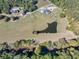 Expansive aerial view of a property featuring a serene pond, verdant fields, and a charming home nestled in nature at 441 Pumpkinvine Rd, Acworth, GA 30101