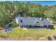 Aerial view of home with spacious backyard, outdoor firepit, and surrounded by lush trees at 441 Pumpkinvine Rd, Acworth, GA 30101
