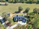Stunning aerial view of custom home with large lawn, fire pit, and modern roofline at 441 Pumpkinvine Rd, Acworth, GA 30101