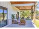 Inviting covered back porch with comfortable seating and relaxing swing chairs at 441 Pumpkinvine Rd, Acworth, GA 30101