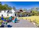 Inviting backyard firepit area with colorful Adirondack chairs, surrounded by well-manicured landscaping and gravel at 441 Pumpkinvine Rd, Acworth, GA 30101