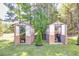 Two backyard greenhouses set in a well maintained grassy lawn at 441 Pumpkinvine Rd, Acworth, GA 30101
