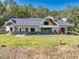Expansive backyard featuring a covered patio, outdoor seating, and a lush green lawn at 441 Pumpkinvine Rd, Acworth, GA 30101
