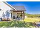 Spacious backyard featuring a covered patio, manicured lawn, and serene views of the surrounding landscape at 441 Pumpkinvine Rd, Acworth, GA 30101