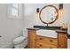 Powder room featuring a granite countertop, apron sink, and decorative mirror at 441 Pumpkinvine Rd, Acworth, GA 30101