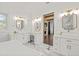 Bright bathroom with white cabinets, marble floors, gold fixtures, and a separate vanity area at 441 Pumpkinvine Rd, Acworth, GA 30101