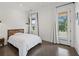 Well-lit bedroom with polished concrete floors, light walls, and a view of the yard at 441 Pumpkinvine Rd, Acworth, GA 30101