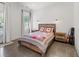 This bedroom features a wooden frame bed, bear themed pillows, and great natural light at 441 Pumpkinvine Rd, Acworth, GA 30101