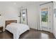 A well-lit bedroom with polished concrete floors, modern decor, and access to the outdoors at 441 Pumpkinvine Rd, Acworth, GA 30101