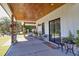 Expansive covered patio featuring a stained wood ceiling, ample seating, and sliding doors to the backyard at 441 Pumpkinvine Rd, Acworth, GA 30101