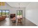 Bright dining room with elegant chandelier, wood table, and views of the outdoor landscape through large windows, offering a serene setting at 441 Pumpkinvine Rd, Acworth, GA 30101