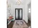 Elegant entryway with modern lighting, shiplap walls, and unique iron front doors at 441 Pumpkinvine Rd, Acworth, GA 30101