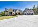 Spacious home showcasing a well-manicured lawn, a three-car garage, and a light brick and white exterior at 441 Pumpkinvine Rd, Acworth, GA 30101