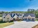 Beautiful brick and siding home with a three-car garage and well-manicured lawn at 441 Pumpkinvine Rd, Acworth, GA 30101