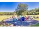 Inviting gravel fire pit area with colorful Adirondack chairs offers the perfect outdoor gathering space at 441 Pumpkinvine Rd, Acworth, GA 30101