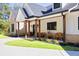 Inviting front porch showcasing a white exterior with charming wood accents, and manicured landscaping at 441 Pumpkinvine Rd, Acworth, GA 30101