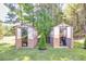 Charming backyard featuring two greenhouses on a lush green lawn, ideal for gardening enthusiasts at 441 Pumpkinvine Rd, Acworth, GA 30101