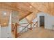 Hallway featuring wood ceiling, hardwood floor, brick accent wall, and wood railing for a craftsman style design at 441 Pumpkinvine Rd, Acworth, GA 30101