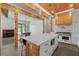Open floor plan with kitchen island, modern appliances, view to dining table, exposed beams, and wood ceiling at 441 Pumpkinvine Rd, Acworth, GA 30101