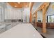 Bright kitchen featuring a large island with stone countertops and white cabinets with wooden accents at 441 Pumpkinvine Rd, Acworth, GA 30101