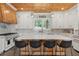 Well-equipped kitchen features an island with seating, modern appliances, white cabinets and wooden accents at 441 Pumpkinvine Rd, Acworth, GA 30101