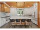 Gourmet kitchen with wood ceiling, white cabinets, large island, stone backsplash, and stainless steel appliances at 441 Pumpkinvine Rd, Acworth, GA 30101