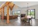 Open-concept living room with wood beams, fireplace, and polished concrete floors at 441 Pumpkinvine Rd, Acworth, GA 30101