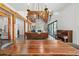 Bright open floor plan featuring exposed beams, a modern kitchen, a dining table, and a stone fireplace at 441 Pumpkinvine Rd, Acworth, GA 30101