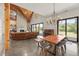 Bright open floor plan featuring exposed beams, a dining table, a piano, a fireplace, and large windows at 441 Pumpkinvine Rd, Acworth, GA 30101