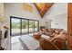 Sunlit living room featuring sliding glass doors, wood beams, and a soaring ceiling at 441 Pumpkinvine Rd, Acworth, GA 30101