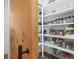Organized pantry with ample shelving, pantry door, and a variety of food items at 441 Pumpkinvine Rd, Acworth, GA 30101