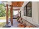 Covered porch showcasing wooden benches, wooden columns, and a stained wood ceiling at 441 Pumpkinvine Rd, Acworth, GA 30101