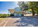 Shed with a covered carport with an open view of a large wooded backyard at 441 Pumpkinvine Rd, Acworth, GA 30101