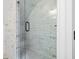 Close-up of the bathroom shower with white and gold vertical tiling at 441 Pumpkinvine Rd, Acworth, GA 30101