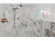This shower features marble-look tile, pebble flooring, and a built-in shower seat at 441 Pumpkinvine Rd, Acworth, GA 30101