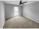 Simple bedroom with neutral carpeting, a window for natural light, and plenty of space for customization at 4958 Meadow Ln, Marietta, GA 30068