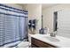 Bathroom featuring a shower-tub combination and a sink with dark wood cabinetry at 5619 Sawgrass Cir, Stonecrest, GA 30038