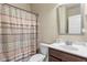 Bathroom features a vanity, mirror, toilet, and a shower with a stylish patterned shower curtain at 5619 Sawgrass Cir, Stonecrest, GA 30038