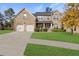 Charming brick two-story home with a well-manicured lawn and a two-car garage at 5619 Sawgrass Cir, Stonecrest, GA 30038