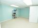 Well-lit basement space with light blue walls and neutral carpet provides a versatile area for storage or hobbies at 100 Cross Creek Dr, Lilburn, GA 30047