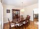 Formal dining room featuring a wooden table with seating for eight and classic chandelier lighting at 100 Cross Creek Dr, Lilburn, GA 30047