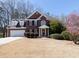 Charming two-story brick home with manicured landscaping, a two-car garage, and a welcoming front entrance at 100 Cross Creek Dr, Lilburn, GA 30047