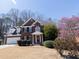 Charming two-story brick home with manicured landscaping, a two-car garage, and a welcoming front entrance at 100 Cross Creek Dr, Lilburn, GA 30047