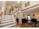 Bright foyer with hardwood floors, staircase with white banister, and an open view to the living room at 100 Cross Creek Dr, Lilburn, GA 30047