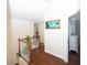 Upstairs hallway features hardwood floors and view of hall bathroom and bedroom at 100 Cross Creek Dr, Lilburn, GA 30047