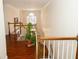 Hallway with hardwood floors has a nice wooden banister and staircase at 100 Cross Creek Dr, Lilburn, GA 30047