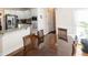 Eat-in kitchen with stainless steel appliances, white cabinets, and a granite countertop breakfast bar at 100 Cross Creek Dr, Lilburn, GA 30047