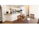 Eat-in kitchen with stainless steel appliances, white cabinets, and a granite countertop breakfast bar at 100 Cross Creek Dr, Lilburn, GA 30047