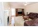 Cozy living room with a fireplace, plush sofa, and a large window with natural light at 100 Cross Creek Dr, Lilburn, GA 30047