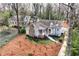 Aerial view of a charming home with a stone chimney, front porch, and mature trees surrounding at 3776 Powers Ferry Nw Rd, Atlanta, GA 30342